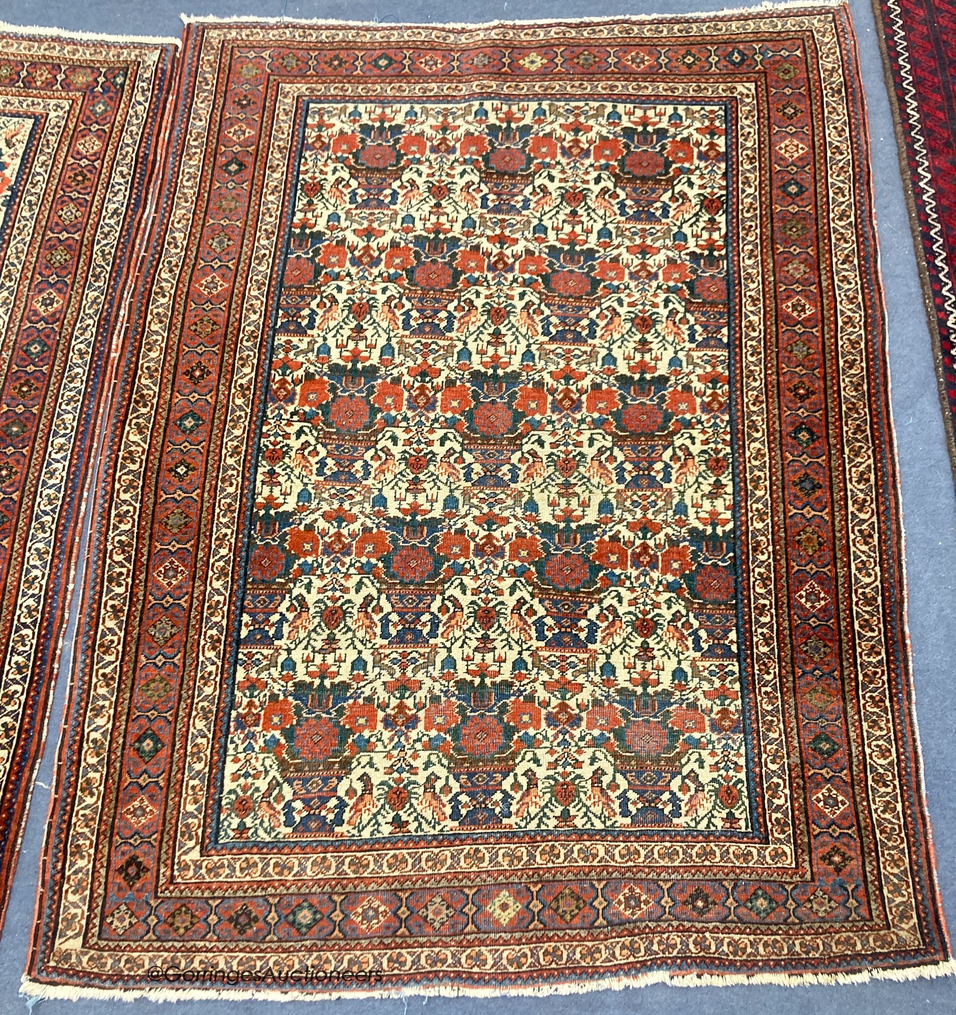 A pair of early 20th century North West Persian ivory ground rugs, woven with birds and vases of flowers, 150 x 110cm